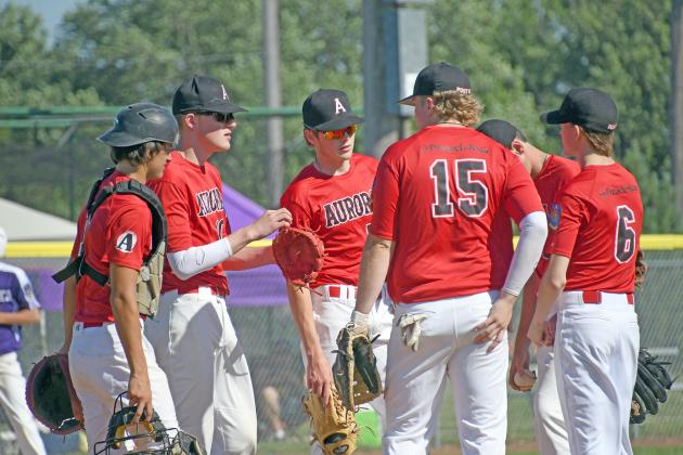 The Aurora Pinnacle Bank Seniors infield has a meeting of the minds during a game earlier this season. 