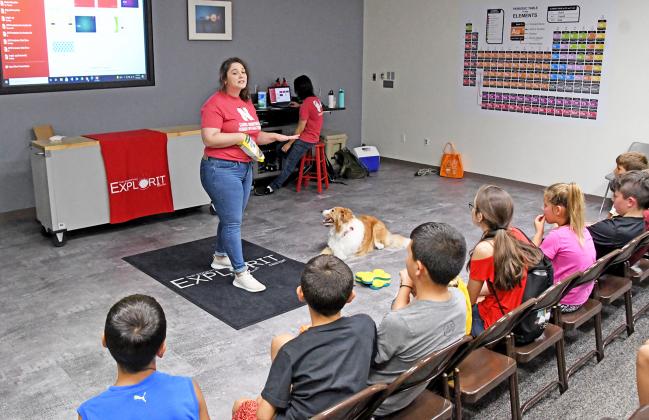 London Wolff with UNL’s Canine Cognition and Human Interaction Lab explains how she works with her dog Linus to the campers.