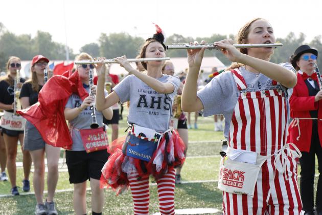Dressed to impress, Willa Sharp (left), Hailey Hanneman and Rachel Hunter count out their steps, being sure to stay in formation as they learn a new visual element during this year’s Aurora High School band camp.