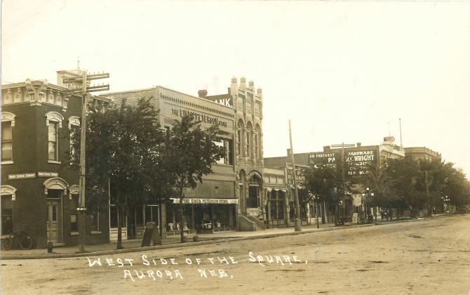 This photo depicts the Einer Peterson Store (at left) on the west side of the square in Aurora.