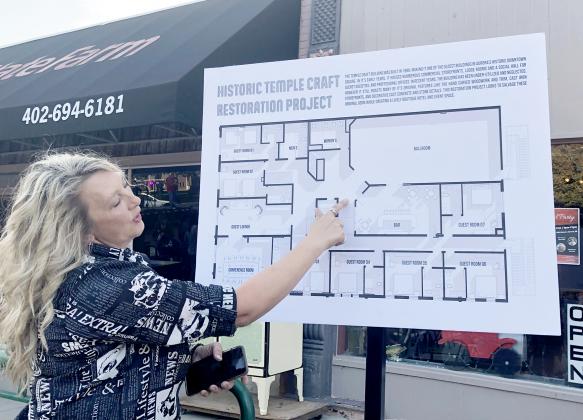 Julie Wetherington helps explain the floor plans for the Temple Craft Restoration Project, which were revealed Saturday evening.