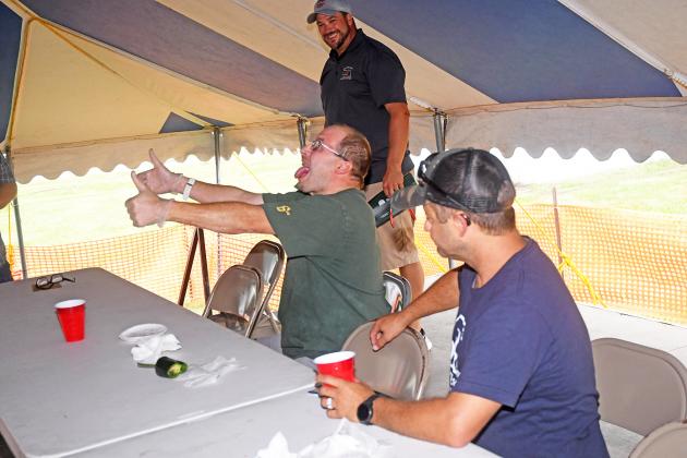 George Brosman (left) shows the crowd that he finished the final pepper in the hot pepper eating contest while Nick Paschke works on drinking some milk to help cool down the heat.