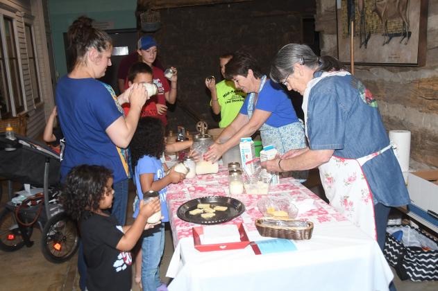 Marsha Pawley, center, explains how cream is turned to butter during a demonstration at the Plainsman Museum’s 2019 Day on the Farm. The event is returning after a one year break.