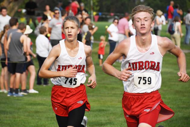 Quinten Smith, right, edges teammate Charlie Evans across the finish line at Friday’s Aurora Invite, helping the Huskies to a third place team finish.