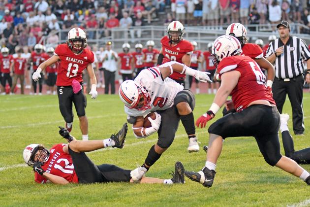 Carlos Collazo tries to keep his feet in heavy Bearcat traffic during Aurora’s 43-22 win at Scottsbluff Friday night. Collazo finished with 137 yards on the ground and three touchdowns.