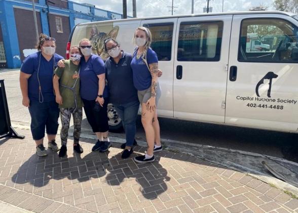 Haley VanDeWalle (left) stands with a rescuer from Zeus’ Place and Capital Humane Society employees Hillary Brandt, Emily Offner and Lindsay Thompson as the prepare for the journey back to Nebraska.