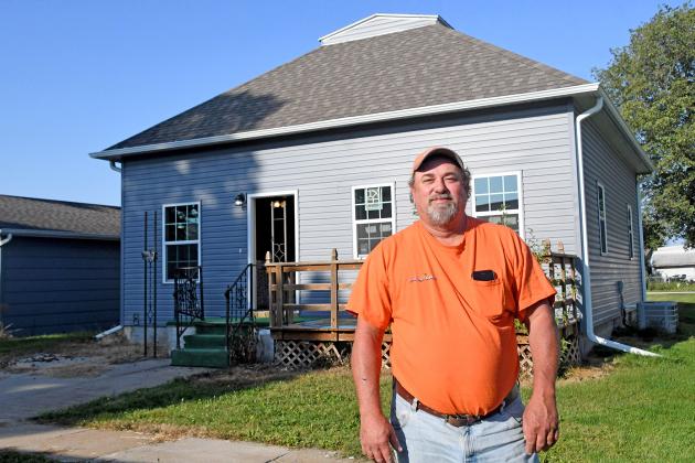Gene Joseph stands in front of the newest home that he has flipped in Hampton.