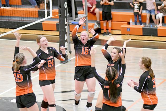 The Lady Hornets celebrate a point during a four-set victory over Nebraska Lutheran Thursday.