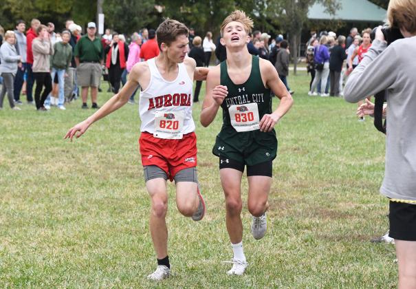In an amazing display of sportsmanship, Aurora’s Tyson Kottwitz encourages Brandon Fye to finish the race as the Central City runner had started to go down just before the finish line.