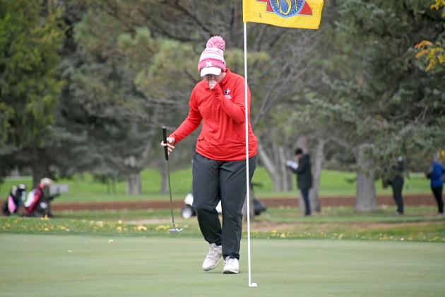 Aurora’s Grace Ziegler watches her putt fall into the cup on the par-3 seventh hole during day two action of the Class B state golf tournament at Scottsbluff Country Club. 