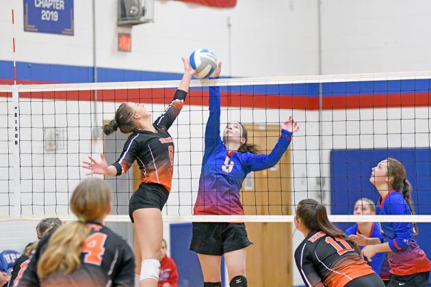 HPC’s Alexis Kalkwarf (right) and Giltner’s Reagen Thompson battle at the net during the Storm’s three-set win over the Hornets Monday. 