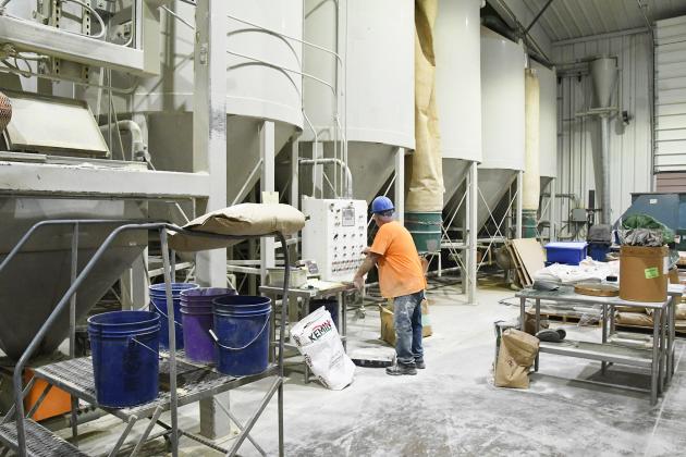 Mark Janzen, a mill room operator at Grain Place Foods, is shown making organic bird food at the plant near Marquette.