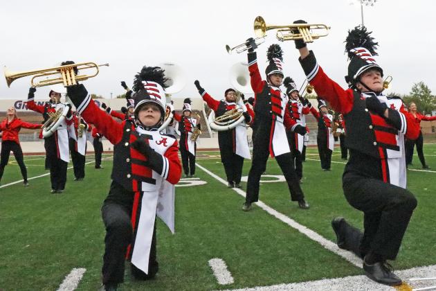 Giving the audience their own version of The Greatest Showman, Aurora band members ended their Harvest of Harmony field competition with flare -- and a flip. Front and center was freshman Keelan Phillips and sophomore Cole Krejci. Senior Alex Peters (center, second row) dazzled the crowd with a song-ending flip in full band regalia.