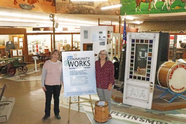 Making a stop in Aurora, Humanities Nebraska associate director Mary Yager (right) was welcomed by Plainsman Museum executive director Tina Larson. Together the duo walked through the ‘Community Works’ exhibition, in which Yager played a key role. 