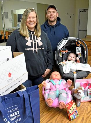 Garrett and Vicki Hill, shown here with their son Wenston, are helping organize a second annual Christmas Free Shop event, scheduled for Dec. 11 in Aurora.