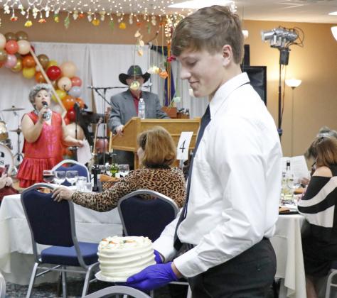 Jacob Ostdiek was one of several AHS students helping with the cake auction Saturday at The Leadership Center’s annual Harvest Gala. 