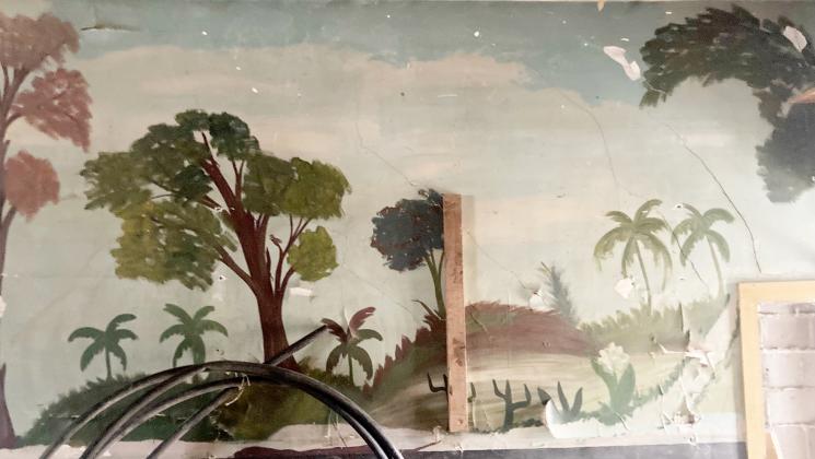 This mural was painted in the 1950s on a wall in a Phillips bar by workers who lived in the community while they helped build the railroad.
