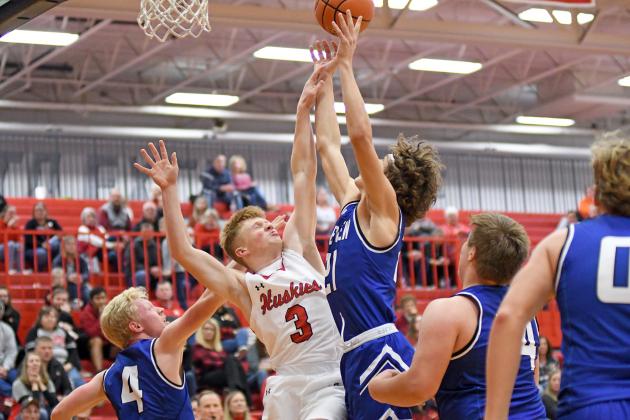 Aurora’s Drew Knust battles through contact for an offensive rebound during a 55-25 win over Columbus Lakeview Friday. 