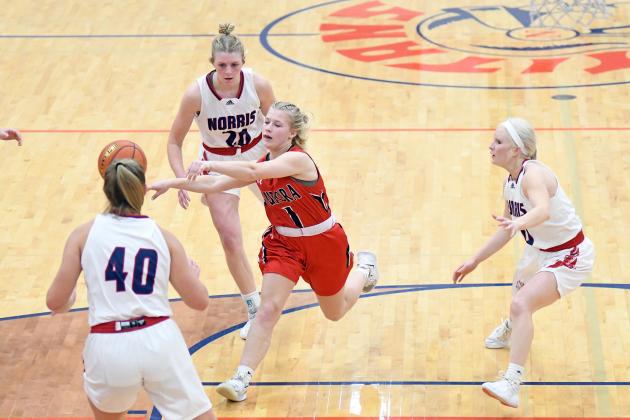 Aurora’s Ellie Hutsell kicks the ball out of a Norris trap at the top of the key during the Lady Huskies’ loss on the road to the Titans Dec. 21. 