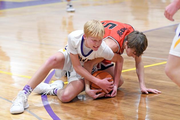 Eli Arndt gets dirty for a loose ball to save a possession in the first half of Hampton’s 48-43 loss to Harvard in the first round of Hampton’s home holiday tournament Monday. 