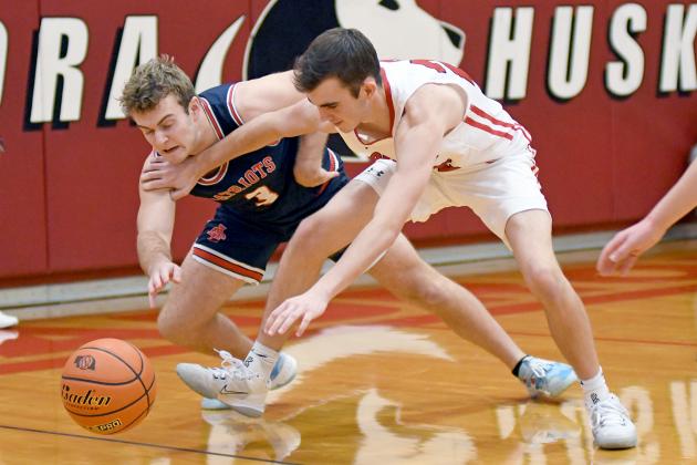 Ethan Jones and Adams Central’s Grant Trausch scramble for the loose ball late in the game of Aurora’s 45-33 win over the Patriots.