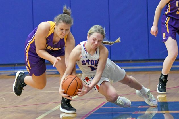 HPC’s Hailey Lindburg lays out for a loose ball over Hampton’s Lillian Dose during the Storm’s 40-35 win over the Hawks Thursday.