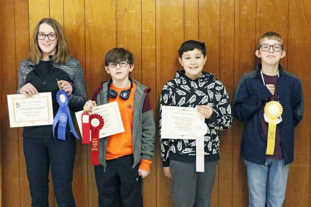 After more than 20 rounds, these four spellers were named the best of the best. They were, from left: Lucy Gustafson of Aurora (first overall), Jayden Betancort of Hampton (second overall), Aiden Roush of Aurora (third overall) and Tanner Schelkopf of Giltner (fourth overall).