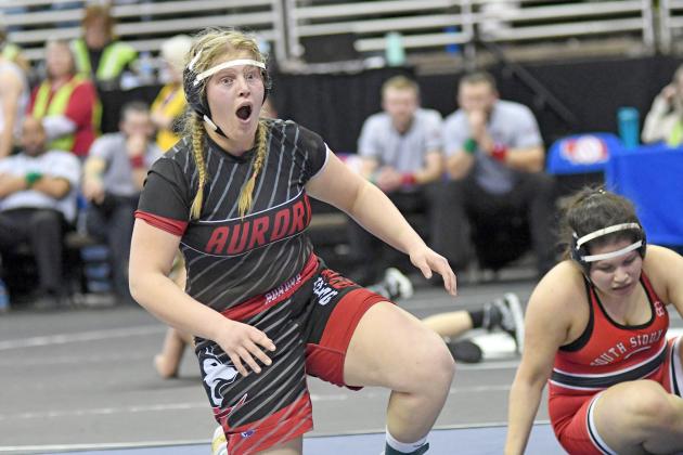 Tia Teigre is overcome with emotion after winning her semifinal match Friday and securing a spot in the first-ever NSAA girls state wrestling finals. 