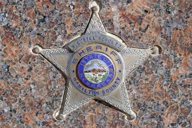 This badge adorns William Schultz’s headstone. The Hamilton County Sheriff’s badge include a color picture of Nebraska in the center and Schultz’s name carved into the top.