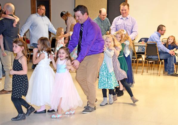 Jason Frew was one of many fathers joining their daughters in a dance train, which paraded around the Bremer Center with a group of smiling young ladies during the third annual Daddy/Daughter Dance.