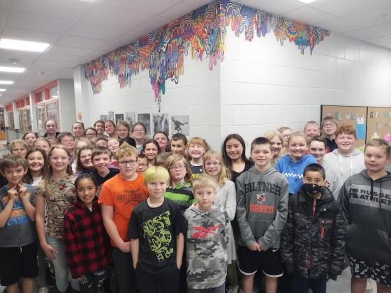 More than 40 Giltner Public School students from three different classes pose in front of the first Jen Stark inspired mural on March 16. The project represents months of work under the direction of art teacher Jenna Hermann.