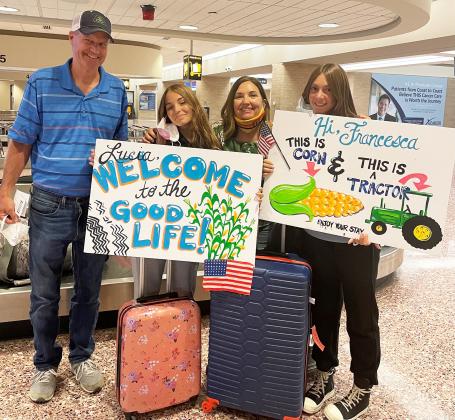 Eric Samuelson, Lucia Ferri, Jule Samuelson and Francesca Di Mare pose in front of a luggage exchange at Omaha’s Eppley Airfield. The girls landed on opposite sides of the airport at the same time. 