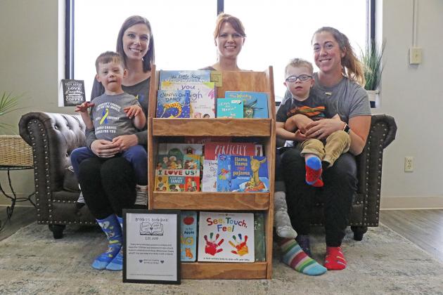 World Down Syndrome Day was celebrated in style March 21 at Coaster’s Coffee in Aurora. Complete with rockin’ socks, Jennifer Heiden (left) and her son Creed, along with Sarah Johnson of Coaster’s and Kim Borrell and her son Brooks, welcomed the installation of Brooks’s Bookshelf at the coffee shop.