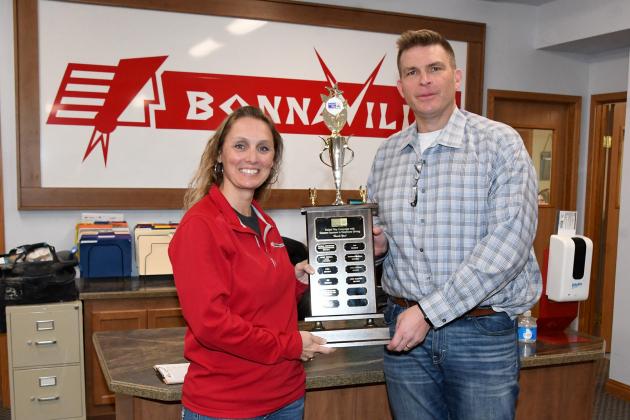 Mike Morrow, general manager at BonnaVilla Homes in Aurora, holds a trophy with HR administrator Monica Kliewer which the company received in recognition of its contribution to the Heartland United Way.
