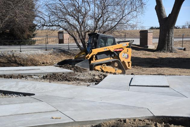 A construction worker smooths out groundwork with a compact track loader at the columbarium site in the Aurora Cemetery March 2.  Construction was started early due to the warm weather. 