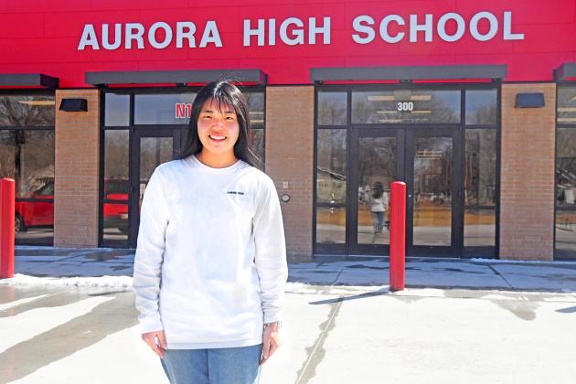 Kana Yamada poses in front of Aurora High School. She has been a foreign exchange student since August and is from Inazawa, Japan.