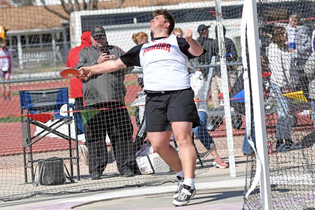 Aurora’s Gage Griffith won the discus (pictured) and shot put events, setting meet records along the way at the Dutch Zorn Invite Thursday. Griffith had throws of 172-01 and 58-04.25, comfortably winning both events. At right, Aurora’s Caden Carlson set a new area-best mark in the pole vault, going 14-06 to finish second Thursday. 