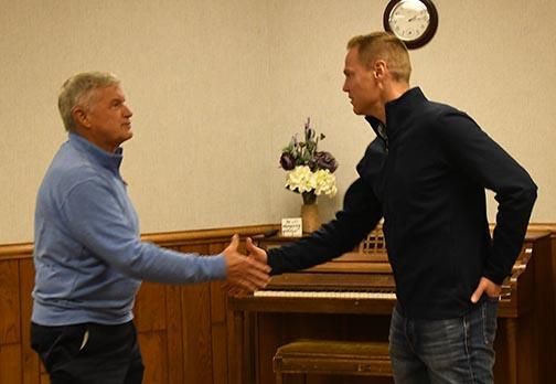 Republican candidate for governor Brett Lindstrom greets Gary Warren of Aurora during Monday's meet and greet.
