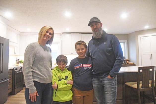 The Bergen family, from left Kelsey, Jase, Jax and Mike, poses in front of their renovated kitchen.