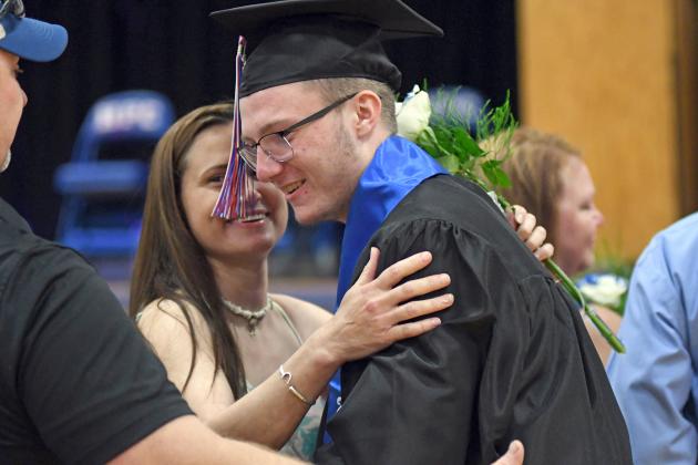 HPC senior Gehrig Urkoski shares a special moment with his mother, Kelly, during graduation exercises Saturday in Polk. 