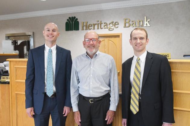 A leadership transition has been announced at Heritage Bank, with Cambell Moyer, right, succeeding his father Sam, center, as chief executive officer. Pictured at left is Jacob Arendt, the bank’s new president. Sam Moyer continues in his role as chairman of the board of Heritage Bank and chairman, CEO and president of Heritage Group, Inc., the bank’s holding company.