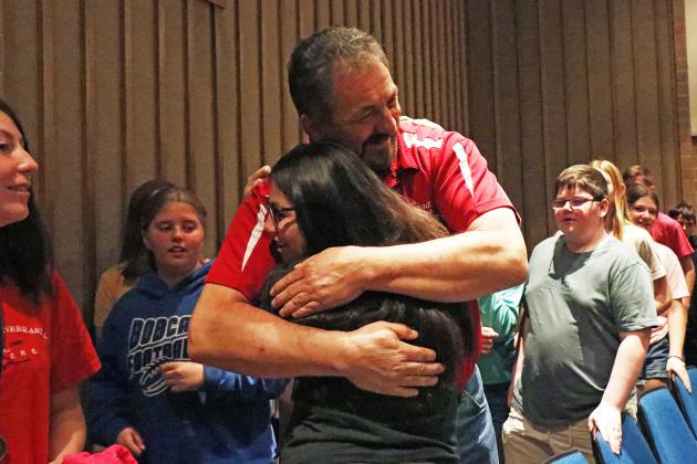 The middle school honors convocation ended in a receiving line of sorts for Maahs, as many students stopped to give him a high-five or hug on the way out of the theater.