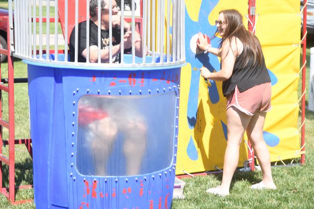 Kailyn Wilson presses the button to dunk Principal Chris Pietrzak into the tank. The volleyball team which sponsored the event had a rule that if an child hits the button, the team members would dunk the principal.