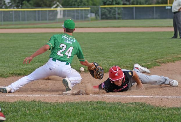 Keegan Chaney makes a dive back to first base in the early hours of Friday’s game against Central City.