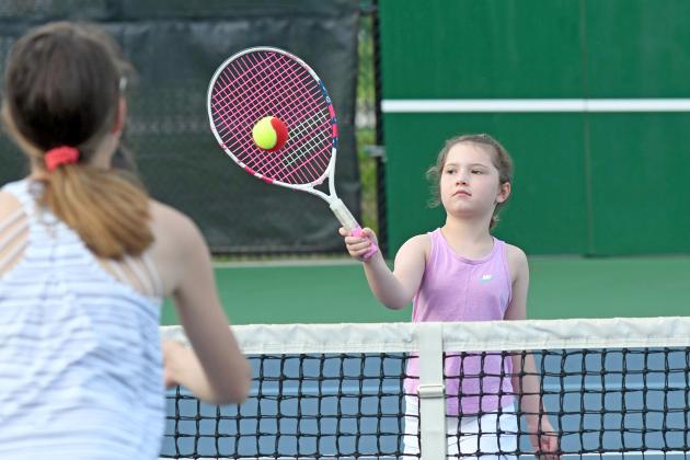 Six-year-old Cara Dennis puts in some time at the Aurora tennis facility early Monday morning. Aurora’s facility will host a six-week tennis clinic for anyone ranging from 5 years old to adults. 