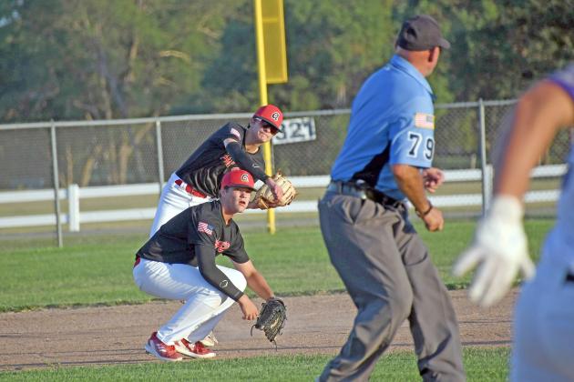 Aurora shortstop Devin Otto fires a grounder over to first base as third baseman Owen McKinney gets low to avoid the throw during a double-header with Minden last week. 