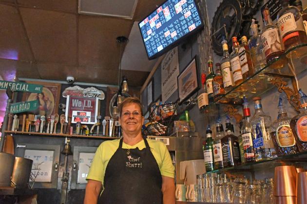 Co-owner Sherri Ditter stands behind the bar next to the screen that displays Keno numbers for the bar and restraurant. Ditter says that the game has brought a steady crowd.