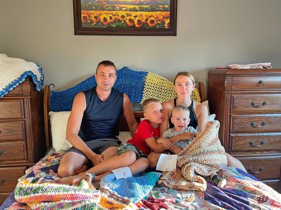 Valeriy, Kyril, Tatiana and Danial lay out their quilts and prayer shawls received from Aurora United Methodist Church. The family moved to Nebraska in mid-July as refugees from Odessa, Ukraine.