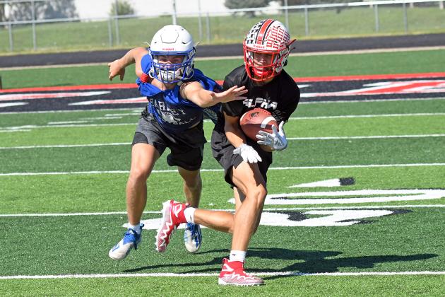 Aurora’s Carsen Staehr makes a quick snag on a curl route and quickly changes direction to score a touchdown during a 7-on-7 contest with Kearney Saturday.