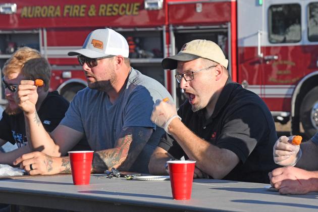 George Brosman, right, defending champion from last year’s pepper eating contest, prepares to down yet another round of heat during Saturday’s event at the Hamilton County Fair. To his left is Troy Bahl of Harvard. Not pictured but also finishing in a four-way tie for first were Steve Williams of Phillips and Matt Bowman of Hampton.